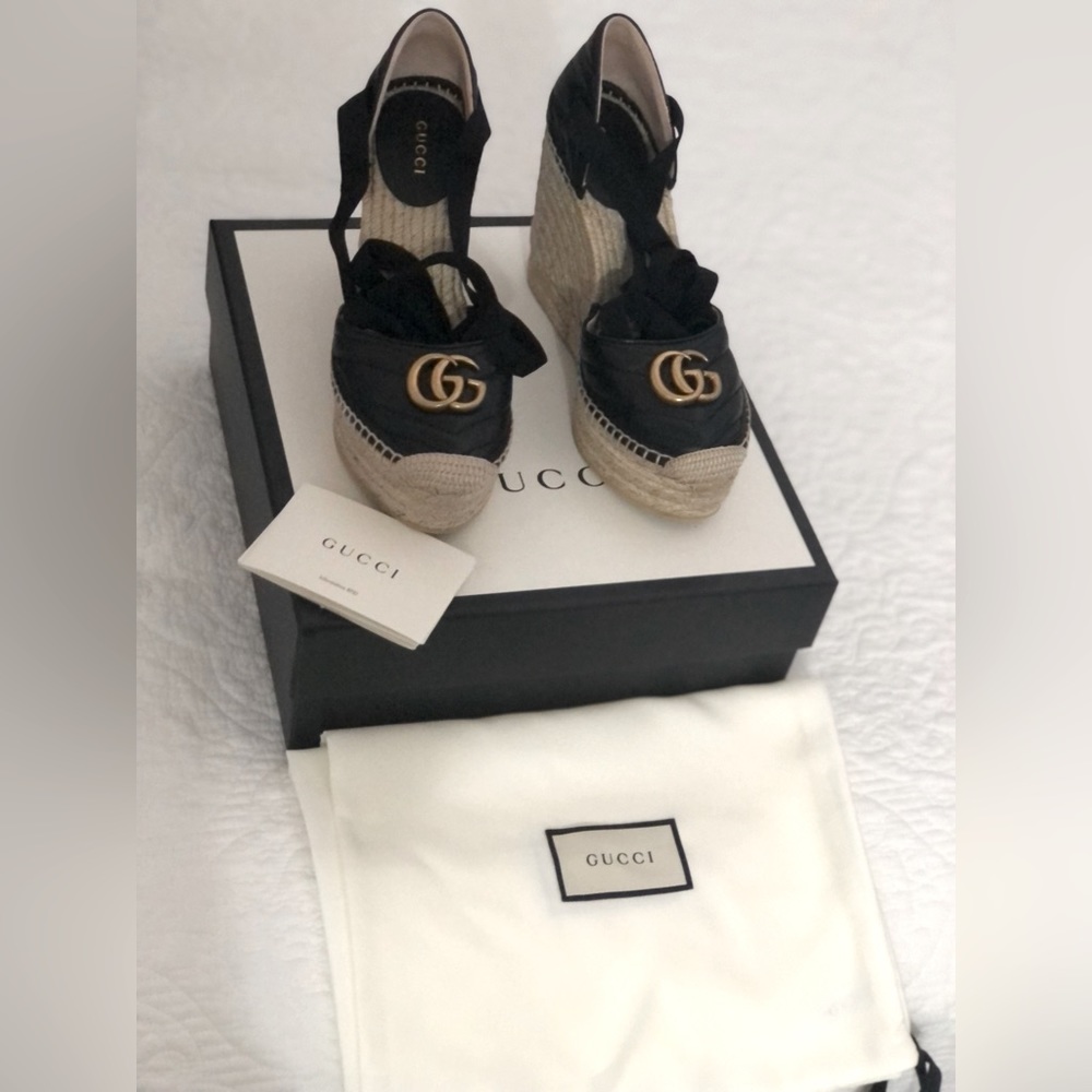 Gucci crafted in black leather set against a cord platform.. worn once